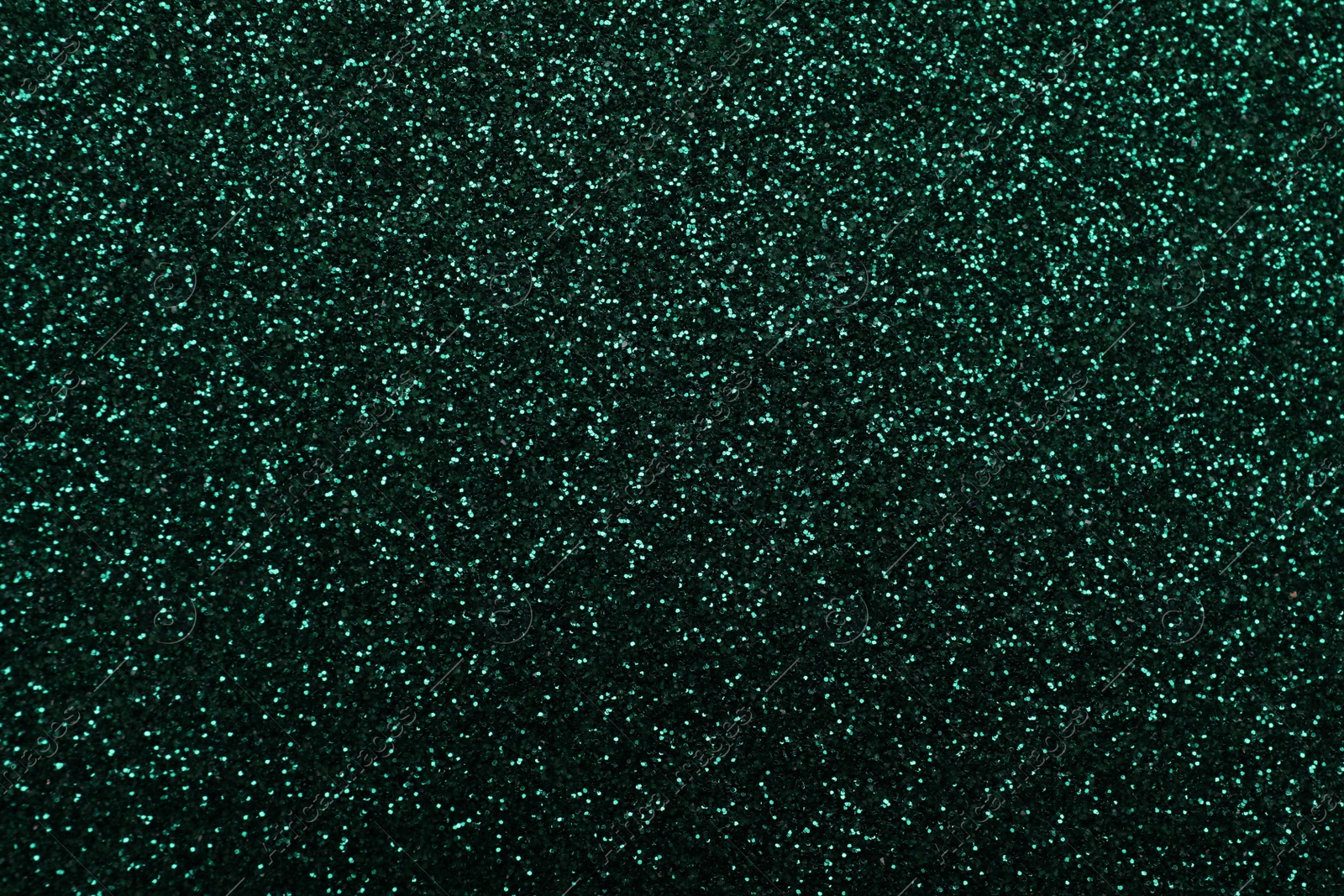 Photo of Shiny dark green glitter as background, closeup