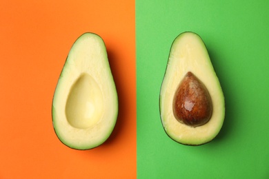 Photo of Cut fresh ripe avocado on color background, flat lay