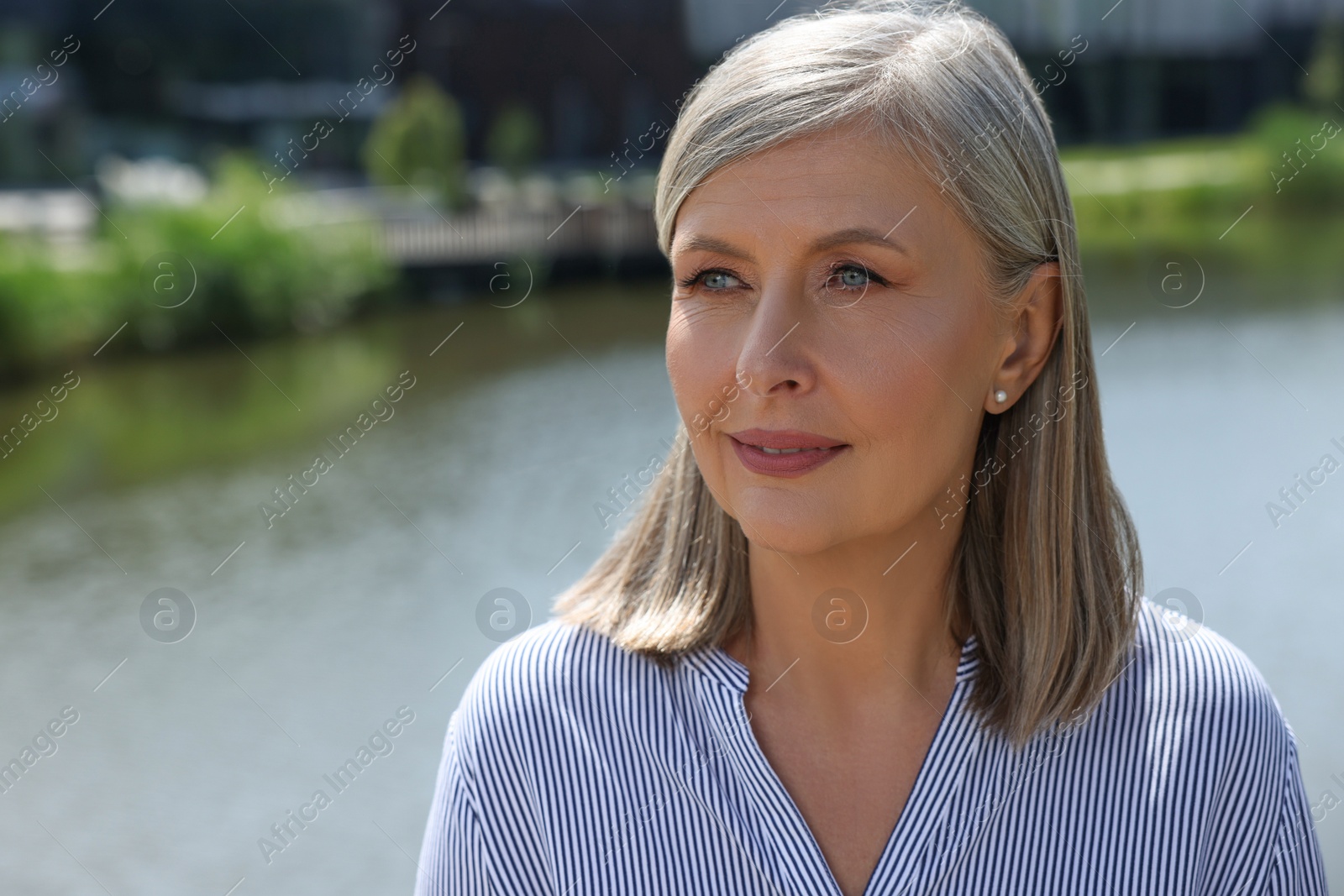 Photo of Portrait of beautiful senior woman outdoors, space for text