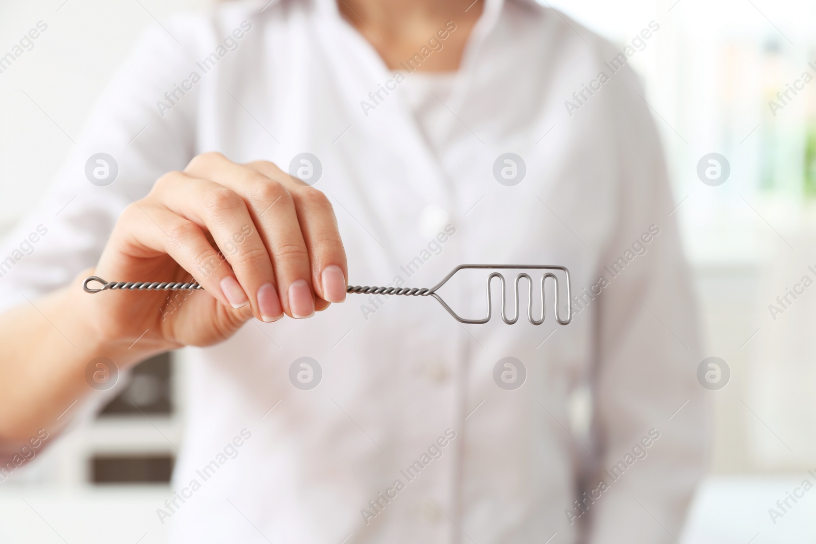 Photo of Speech therapist with logopedic probe in clinic, closeup