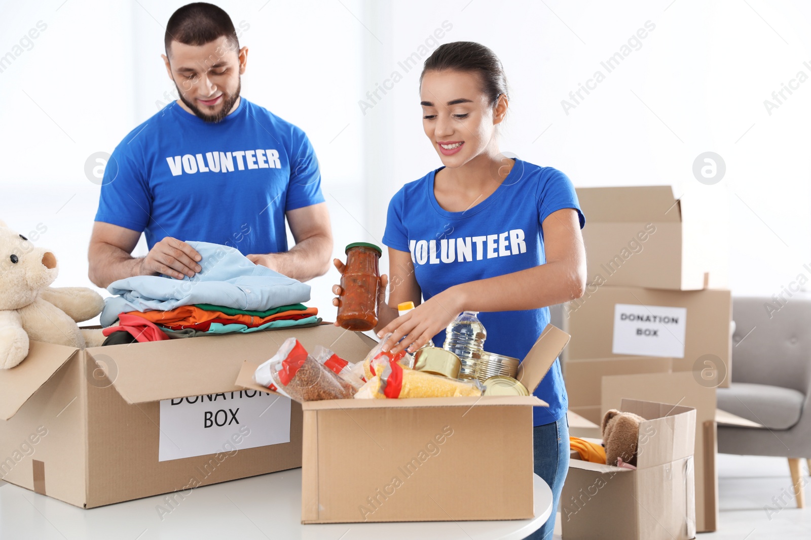 Photo of Young volunteers collecting donations at table indoors