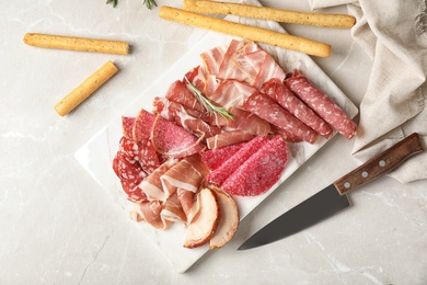 Flat lay composition with different meat delicacies on gray background