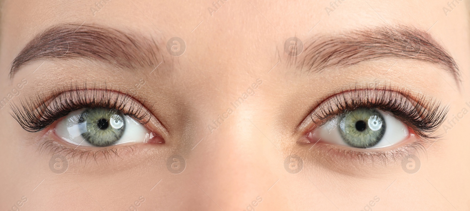 Image of Young woman with beautiful eyelashes after extension procedure, closeup. Banner design