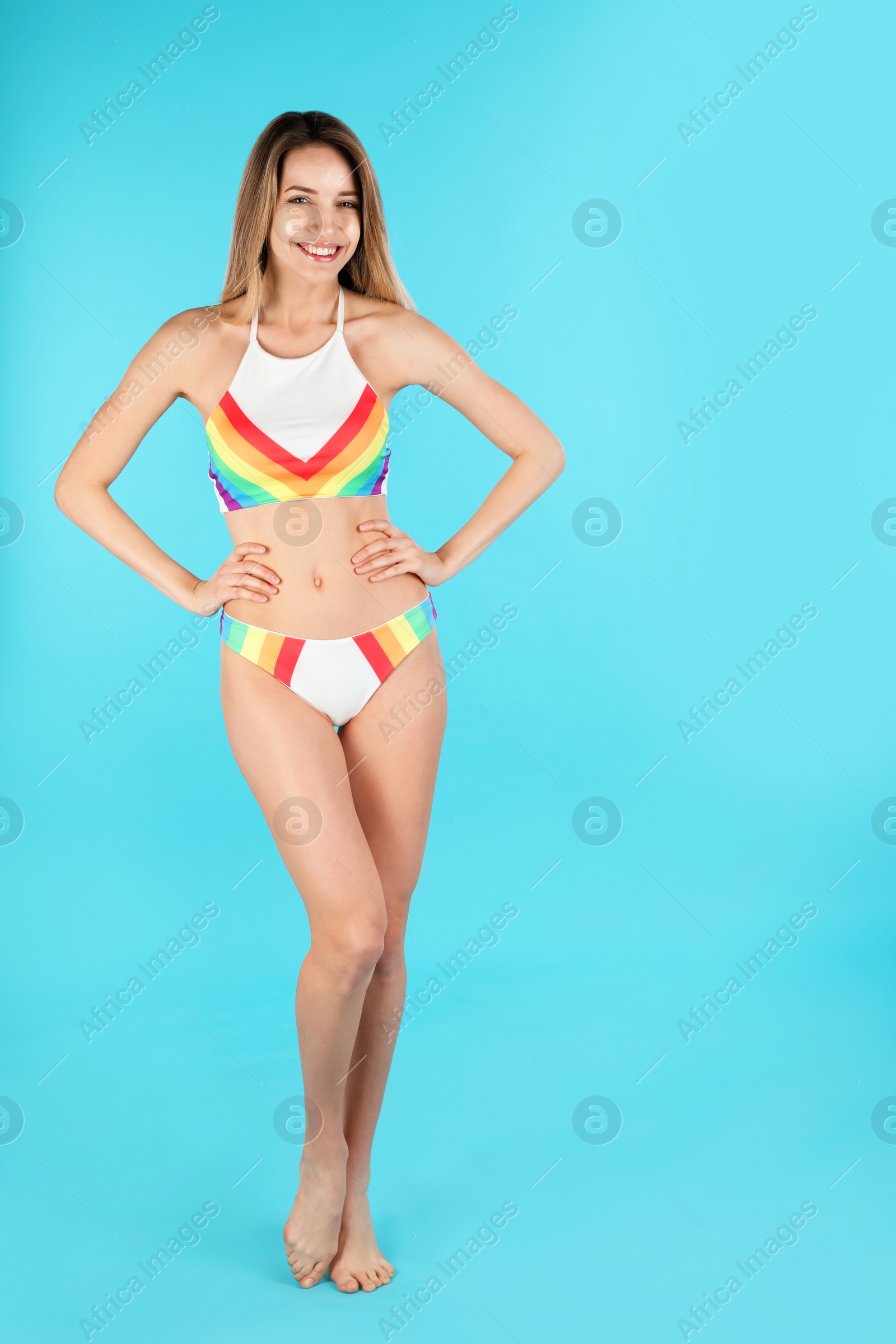 Photo of Young slim woman in bikini on color background, space for text. Perfect body