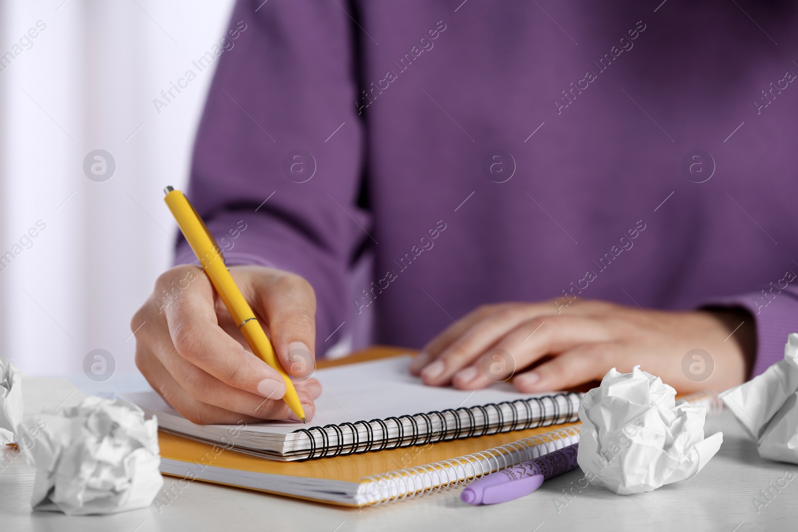 Photo of Woman working at table with crumpled paper, closeup. Generating idea