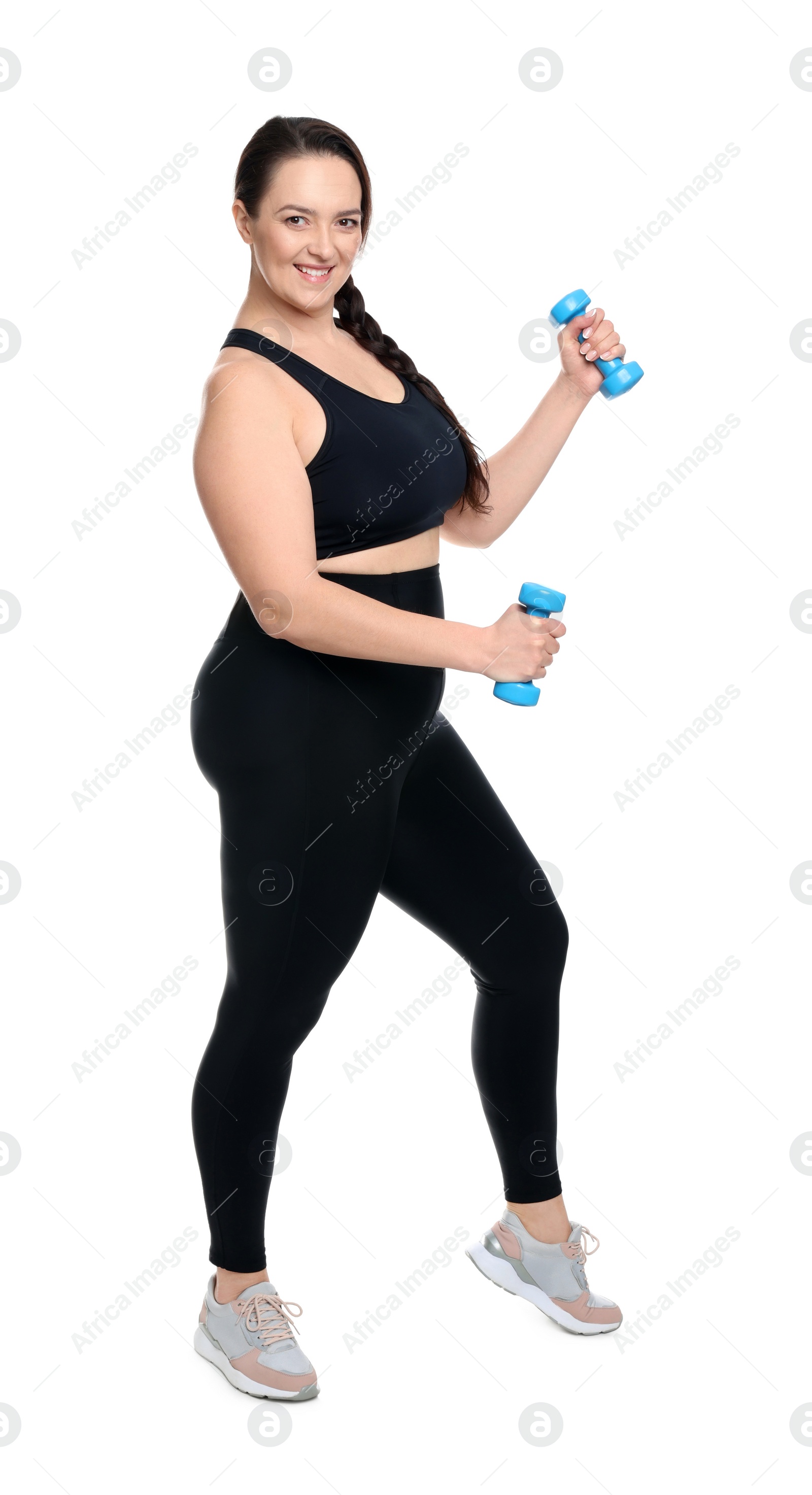 Photo of Happy overweight woman doing exercise with dumbbells on white background
