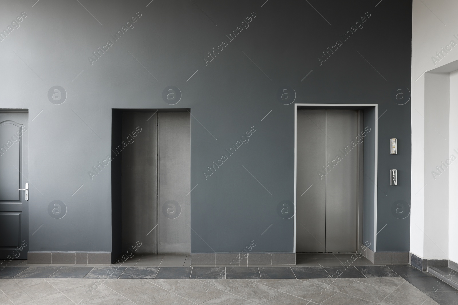 Photo of Closed stylish elevator doors in clean hall