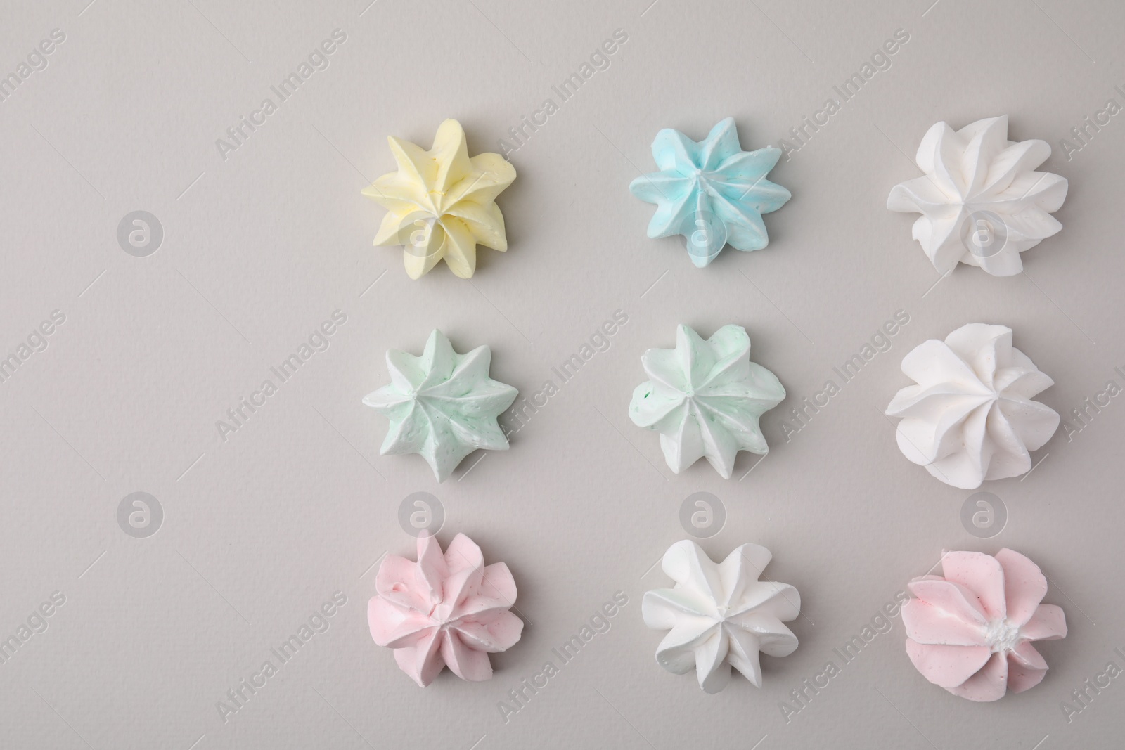 Photo of Delicious meringue cookies on light background, flat lay. Space for text