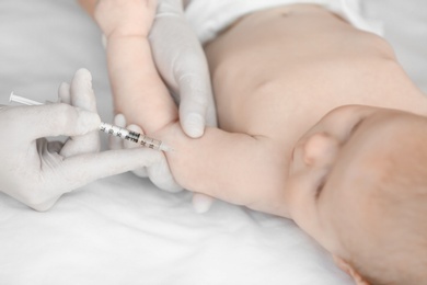 Photo of Doctor vaccinating baby in clinic