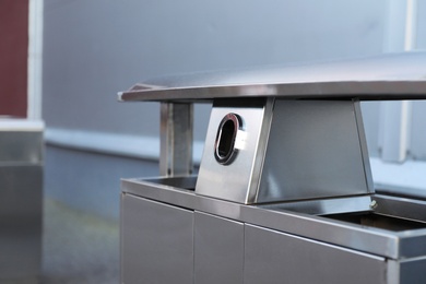 Photo of Modern metal recycling bin outdoors, closeup view. Space for text