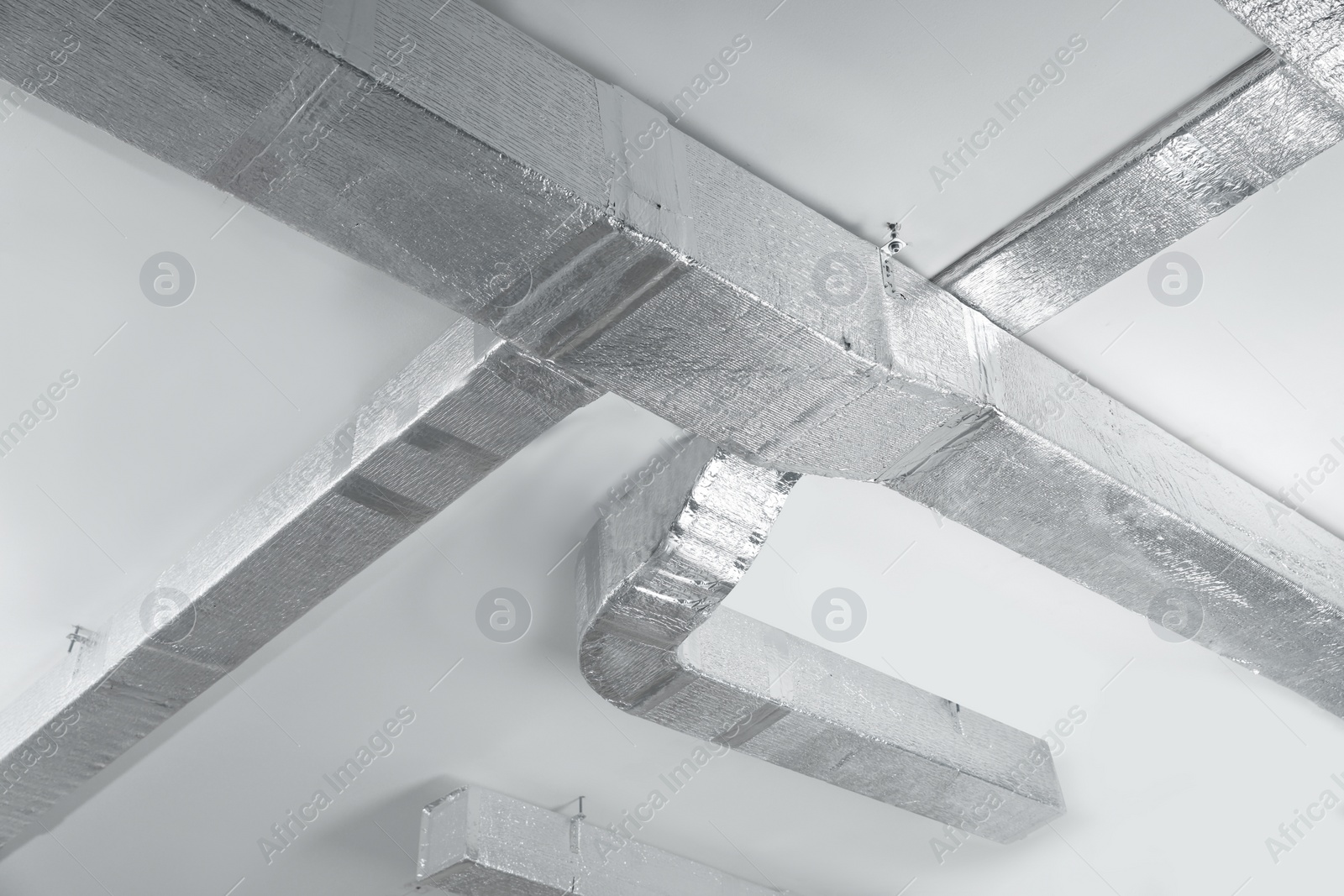 Photo of Ceiling with ventilation system indoors, low angle view