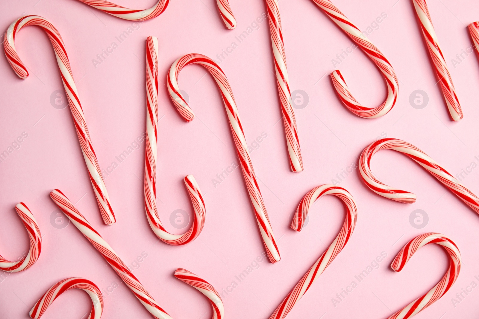 Photo of Flat lay composition with tasty candy canes on color background