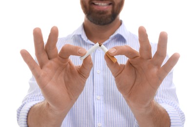 Photo of Stop smoking concept. Man breaking cigarette on white background, closeup