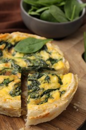 Photo of Delicious pie with spinach on table, closeup