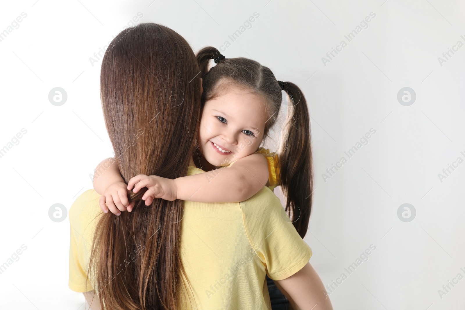 Photo of Young mother with little daughter at home