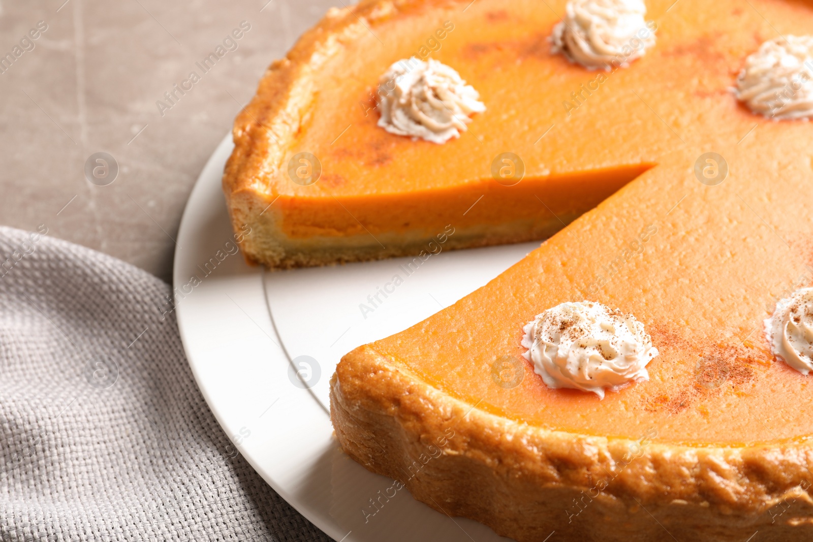 Photo of Fresh delicious homemade pumpkin pie with whipped cream on table