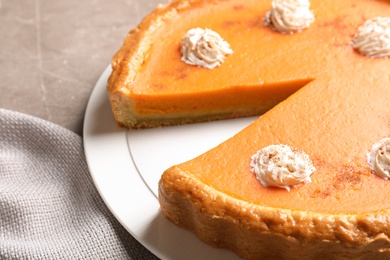 Photo of Fresh delicious homemade pumpkin pie with whipped cream on table