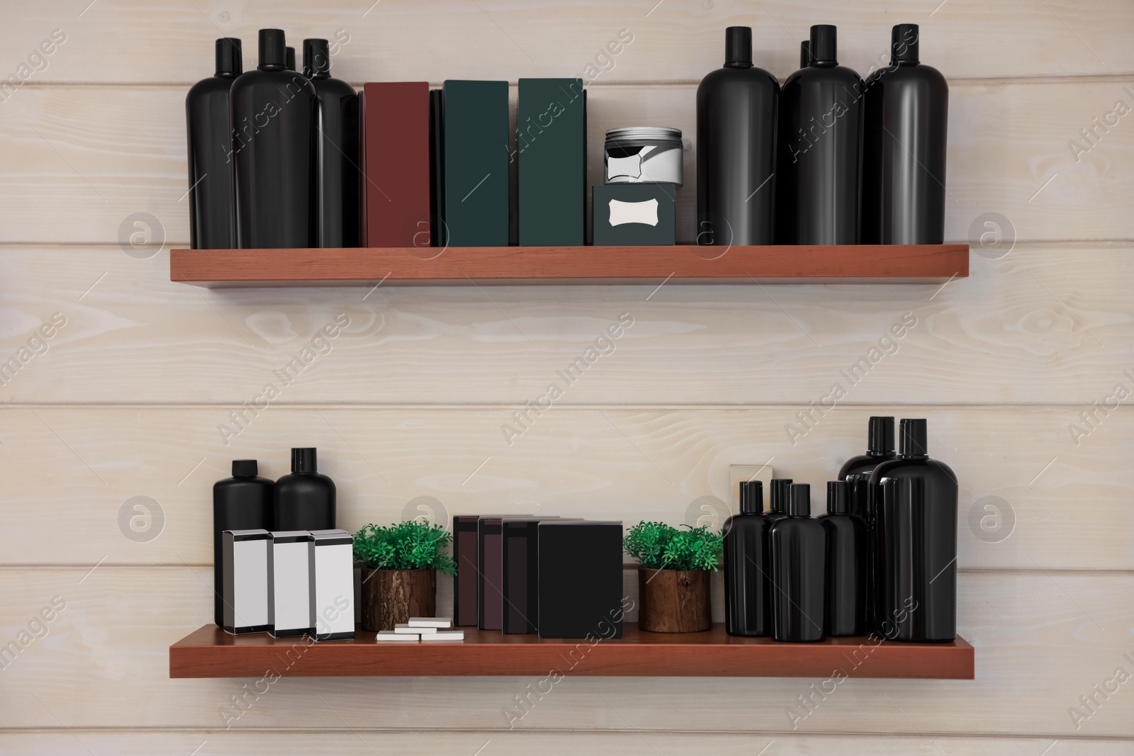 Photo of Shelves with professional hair cosmetics on wall in barbershop