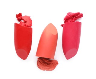 Different beautiful lipsticks on white background, top view