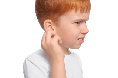 Photo of Little boy suffering from ear pain on white background, closeup