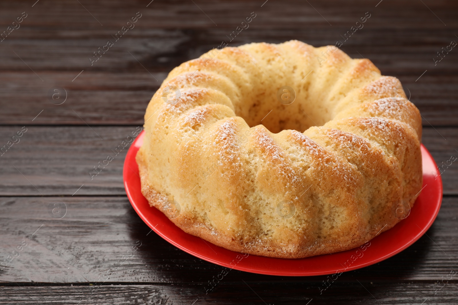 Photo of Delicious freshly baked sponge cake on wooden table, closeup. Space for text