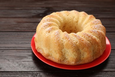 Photo of Delicious freshly baked sponge cake on wooden table, closeup. Space for text