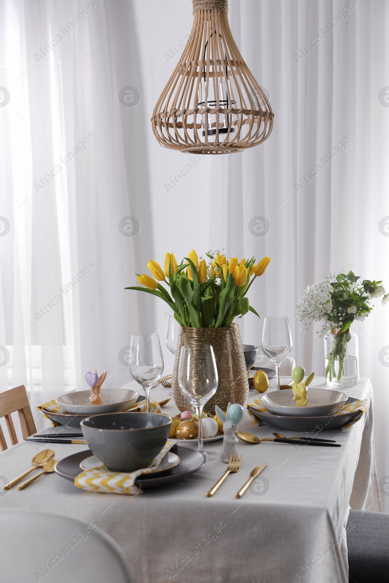 Photo of Beautiful Easter table setting with festive decor indoors