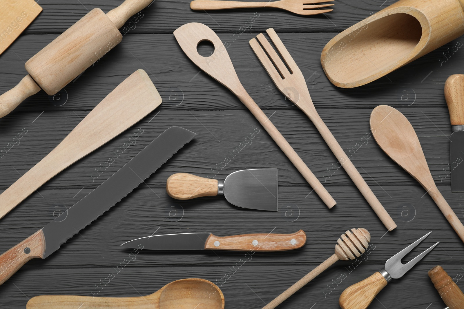 Photo of Set of different kitchen utensils on grey wooden table, flat lay