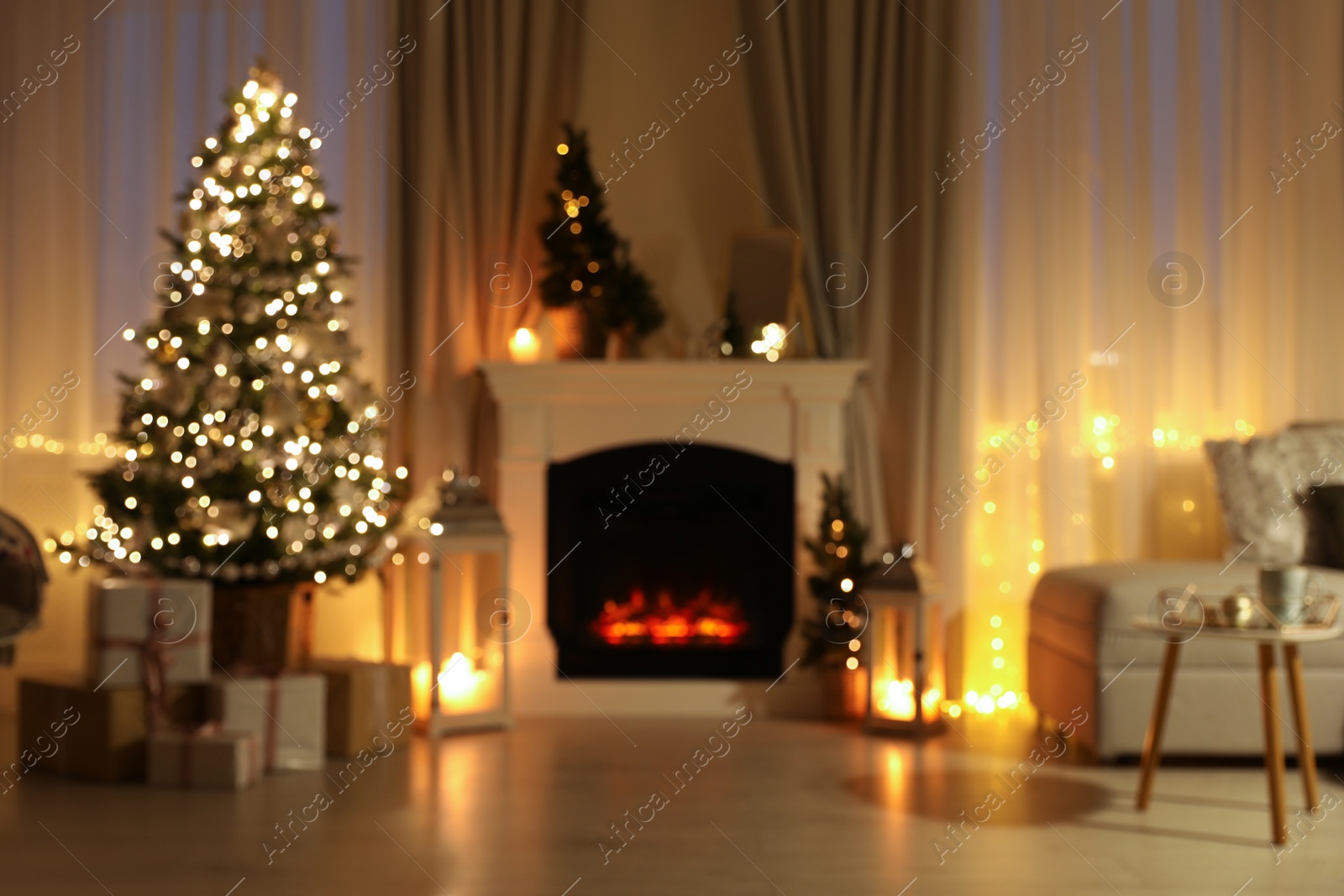 Photo of Stylish living room interior with Christmas tree near beautiful fireplace, blurred view