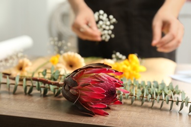 Photo of Beautiful flower and blurred florist on background