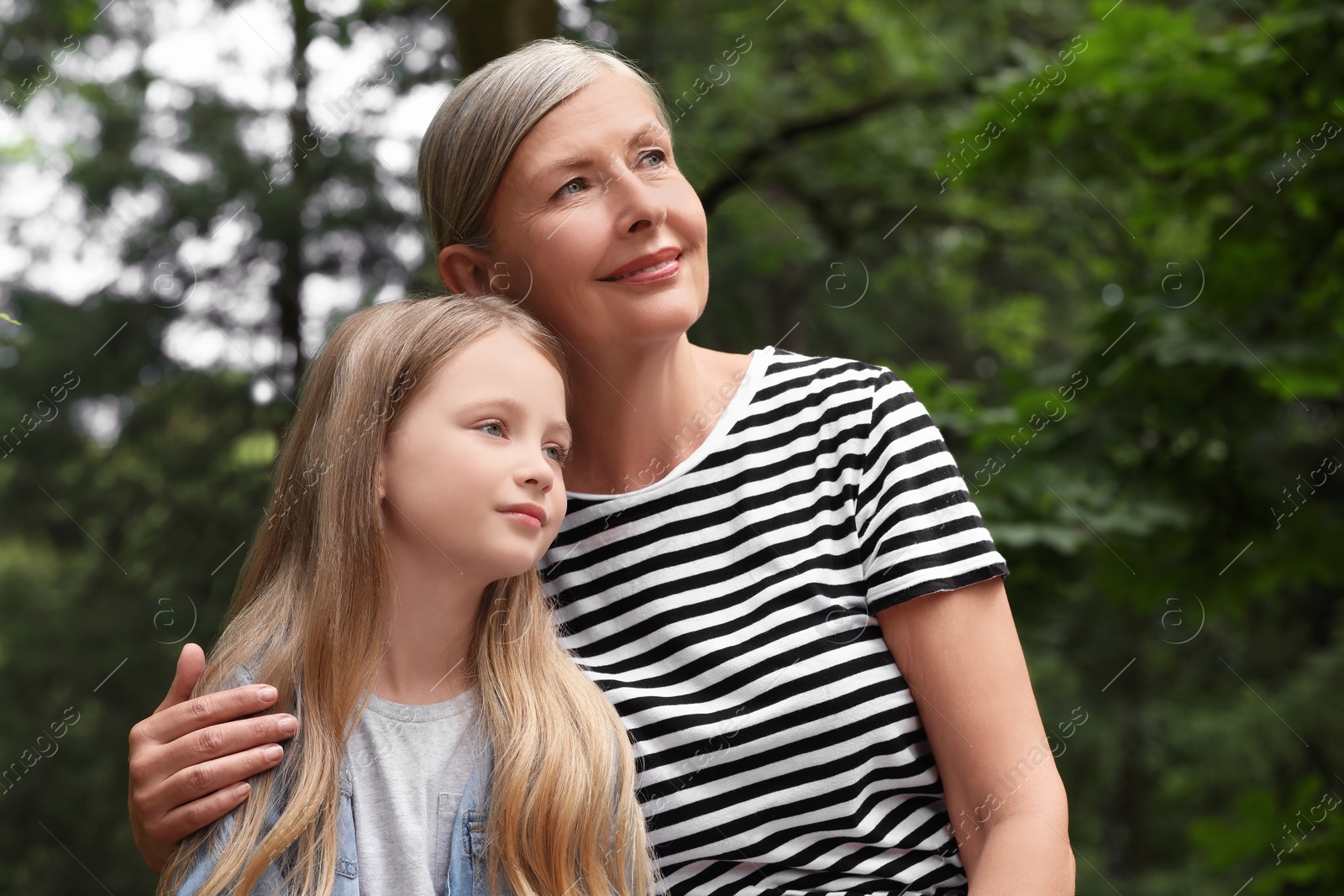 Photo of Happy grandmother with her granddaughter spending time together outdoors