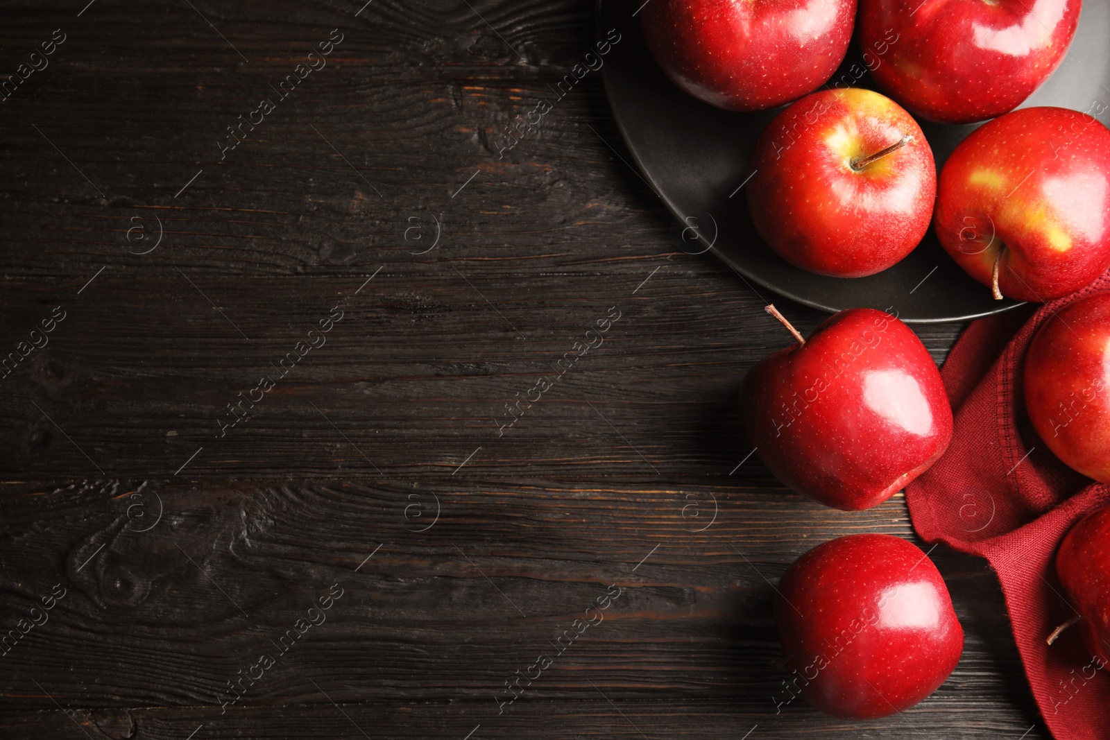 Photo of Flat lay composition with ripe juicy red apples on black wooden table. Space for text