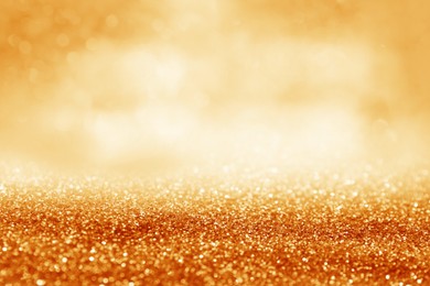 Image of Shiny orange glitter and blurred lights on background. Bokeh effect