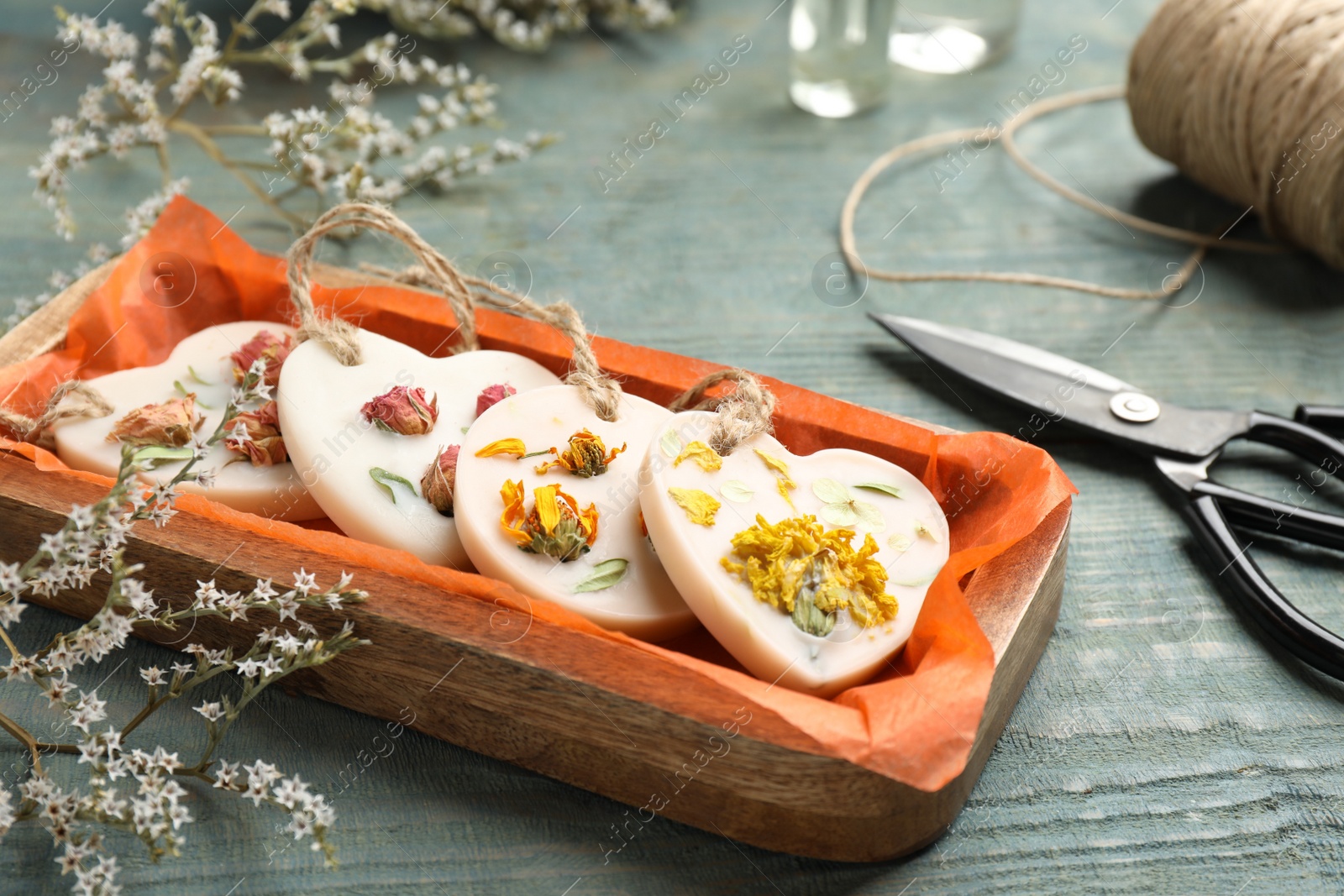 Photo of Tray with scented sachets on blue wooden table