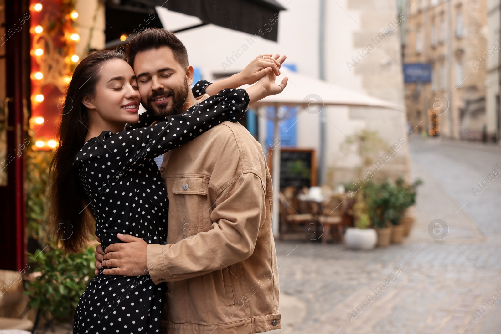 Photo of Lovely couple dancing together on city street, space for text