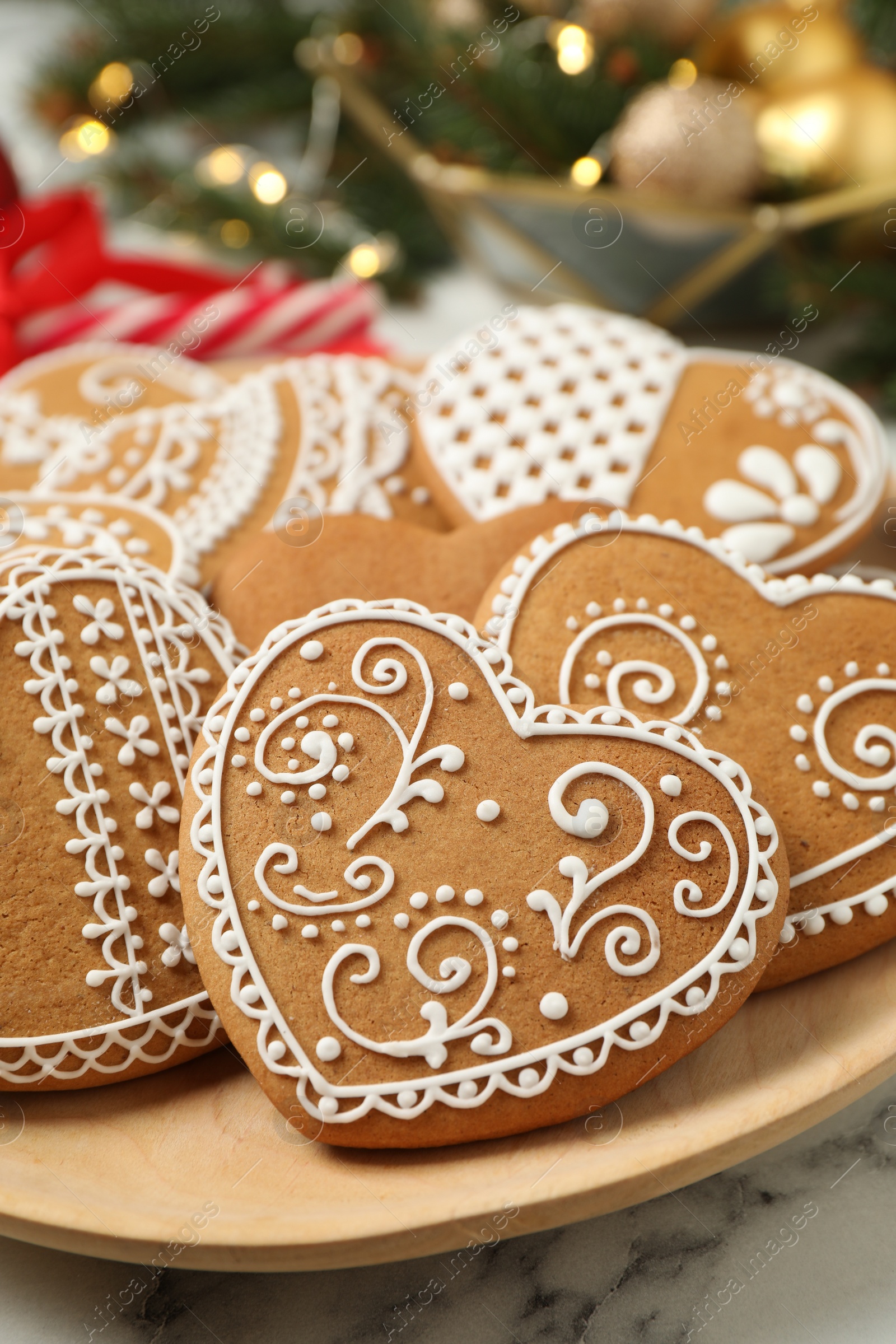 Photo of Tasty heart shaped gingerbread cookies in plate, closeup