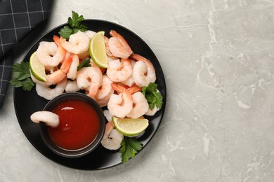 Photo of Tasty boiled shrimps with cocktail sauce, parsley and lime on light grey table, top view. Space for text