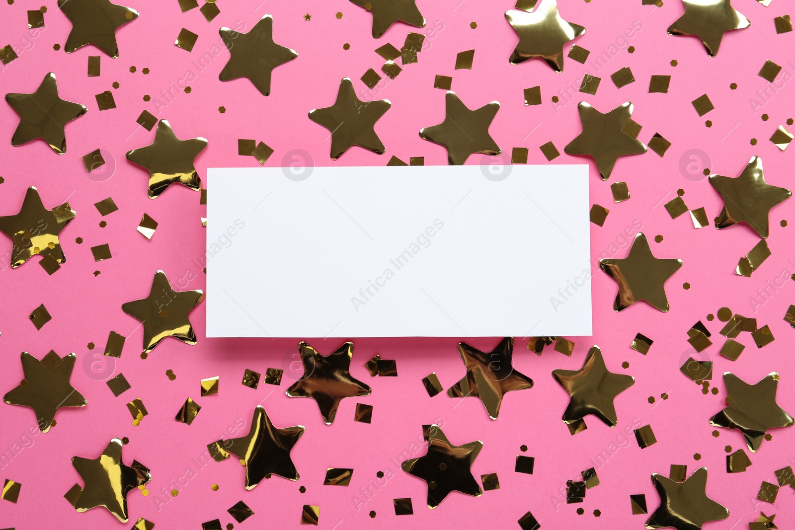 Photo of Blank card and shiny golden confetti on pink background, flat lay. Space for text