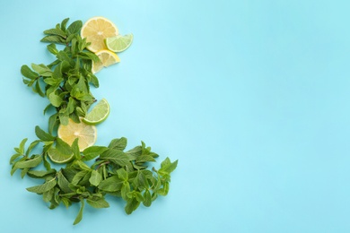 Photo of Fresh mint leaves and citrus fruit on color background, top view