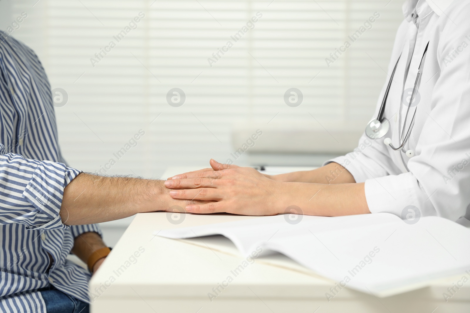 Photo of Patient having appointment with doctor in clinic, closeup