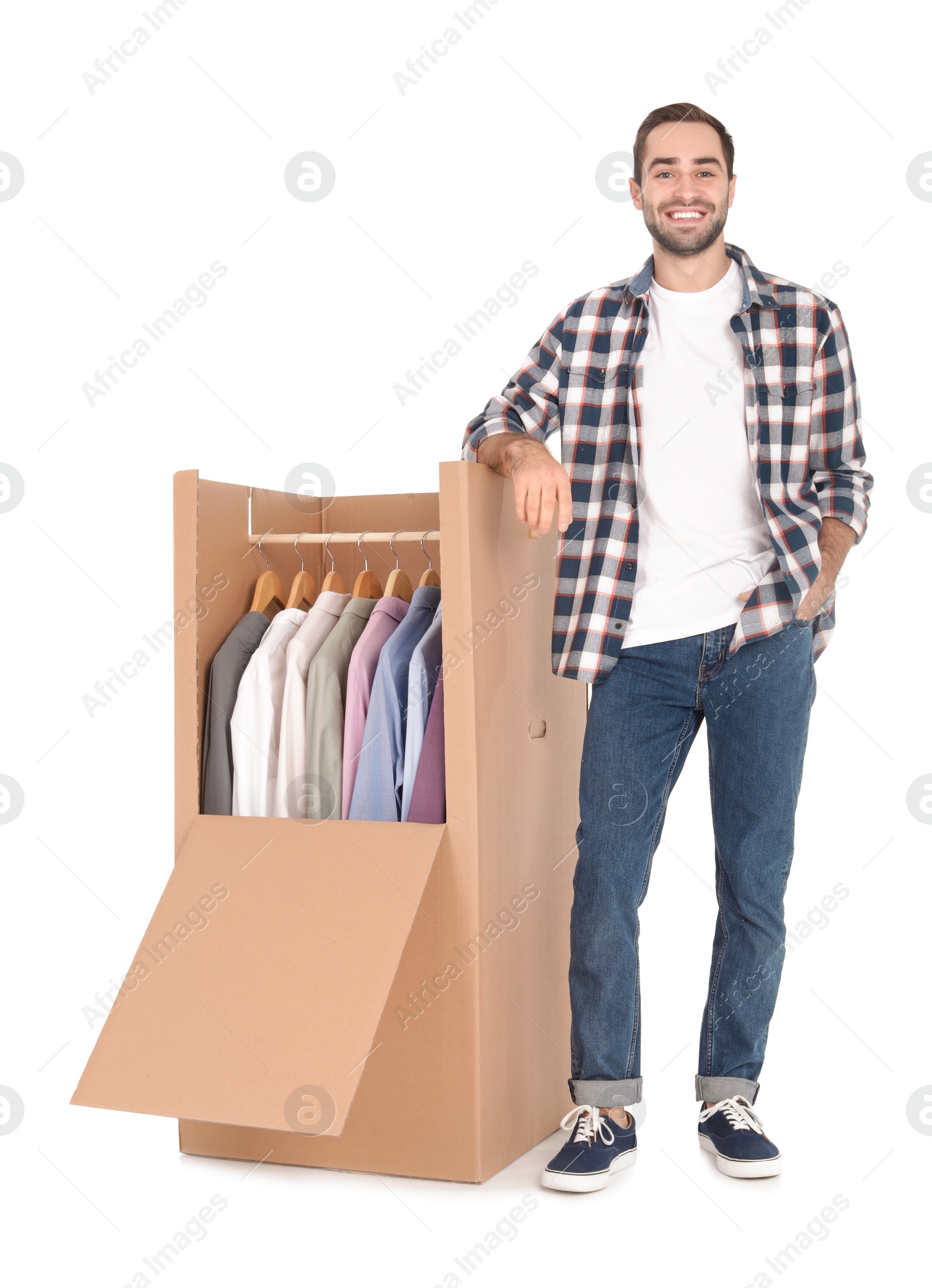 Photo of Young man near wardrobe box on white background