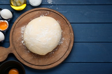 Photo of Fresh yeast dough and ingredients on blue wooden table, flat lay. Space for text