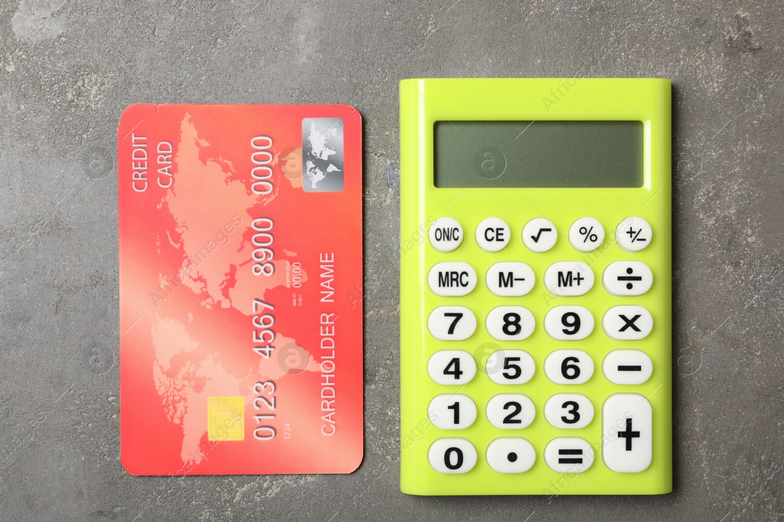 Photo of Credit card and calculator on grey background, flat lay