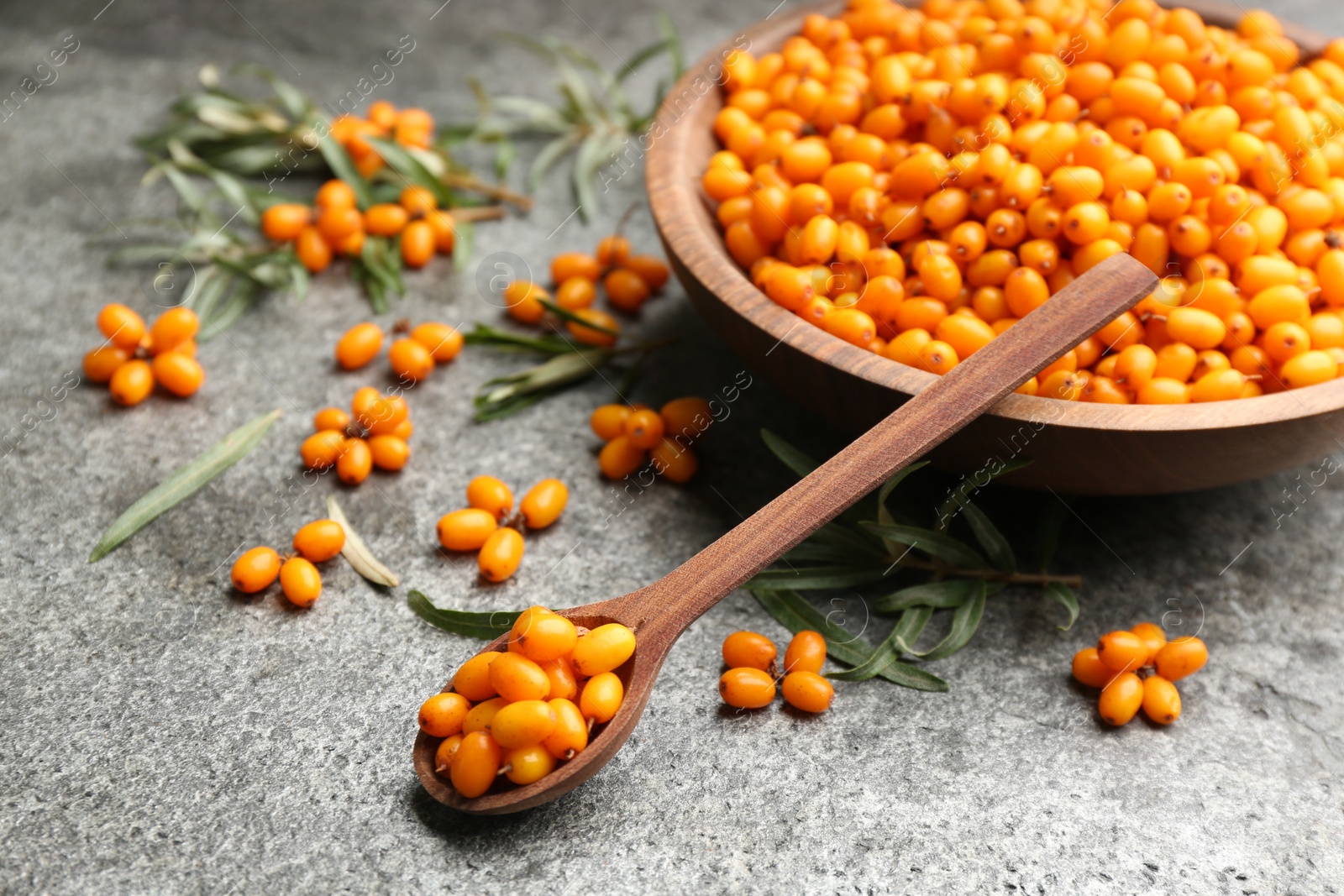 Photo of Fresh ripe sea buckthorn on grey table