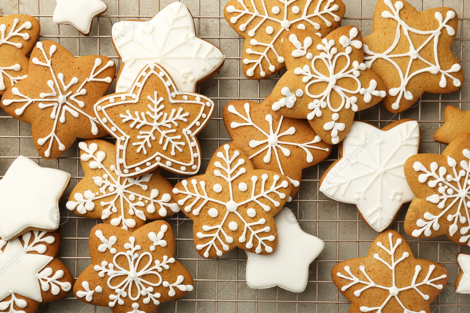 Photo of Tasty Christmas cookies with icing on light table, top view