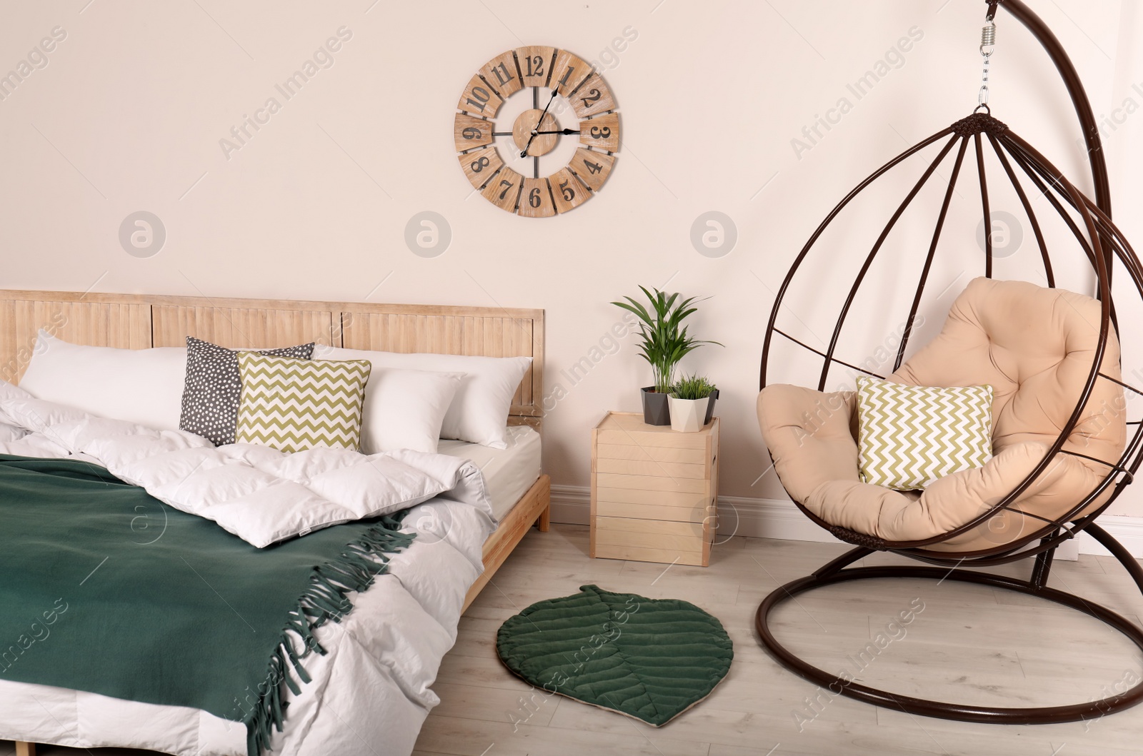 Photo of Modern bedroom interior with comfortable hanging chair. Stylish design