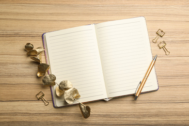 Photo of Stylish notebook on wooden table, flat lay