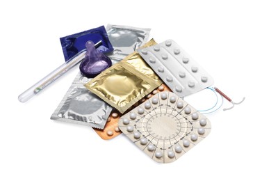 Photo of Contraceptive pills, condoms, intrauterine device and thermometer isolated on white. Different birth control methods