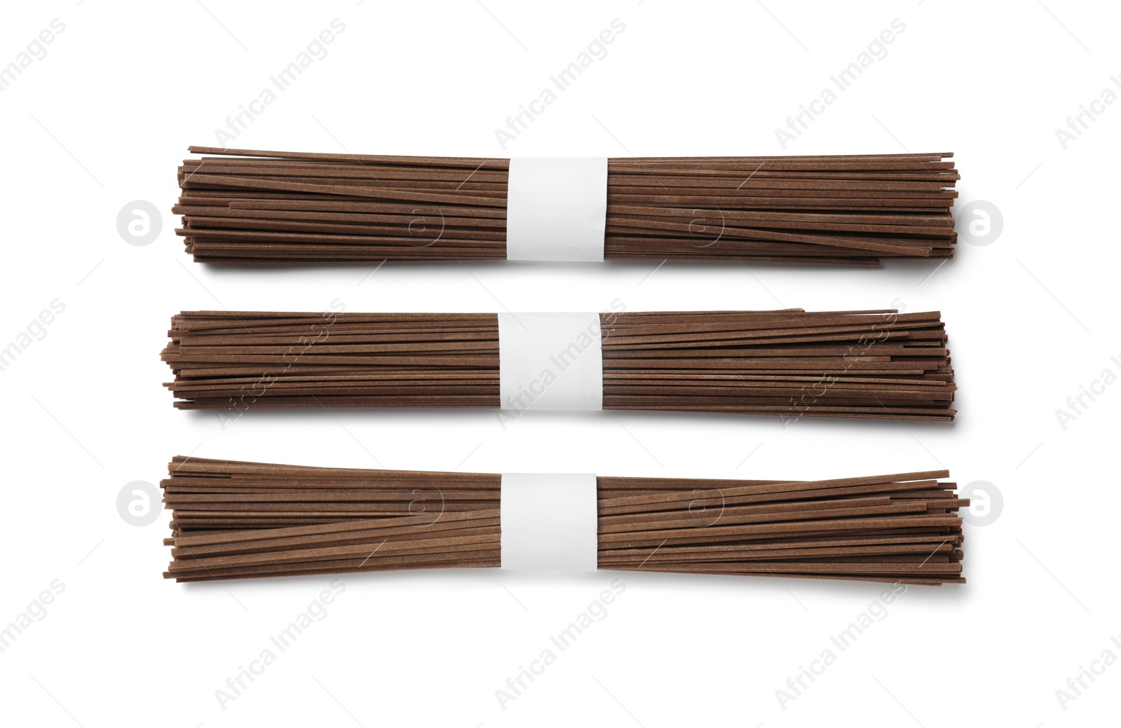 Photo of Uncooked buckwheat noodles (soba) isolated on white, top view