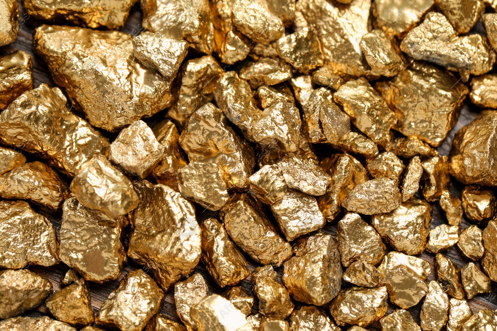 Photo of Pile of gold nuggets as background, top view